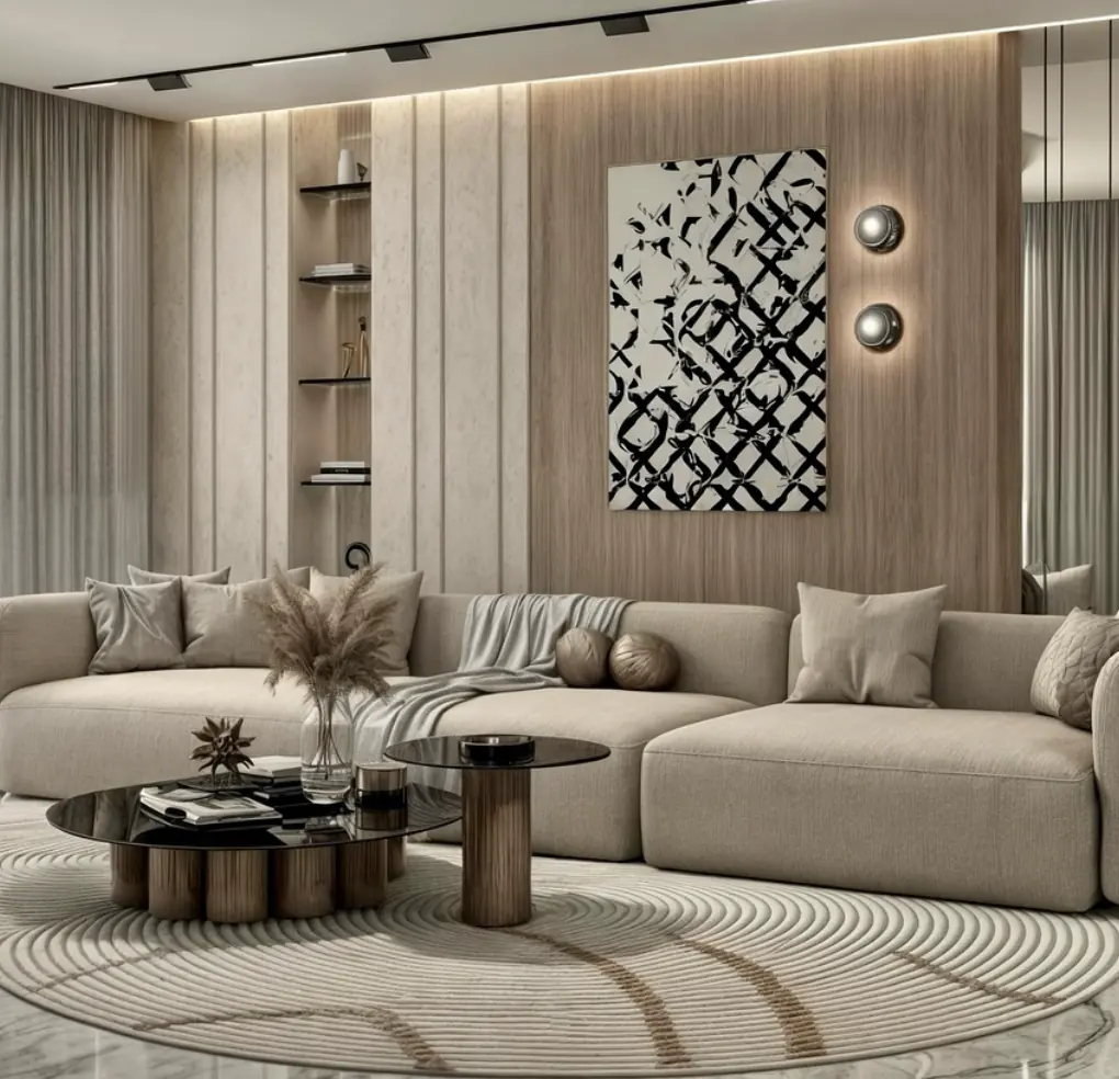 Sand toned living room with a curved sectional, layered rugs and a textured relief artwork